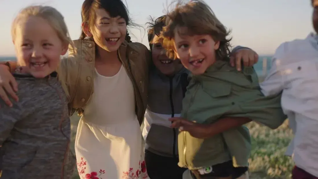 Kids hugging outdoors